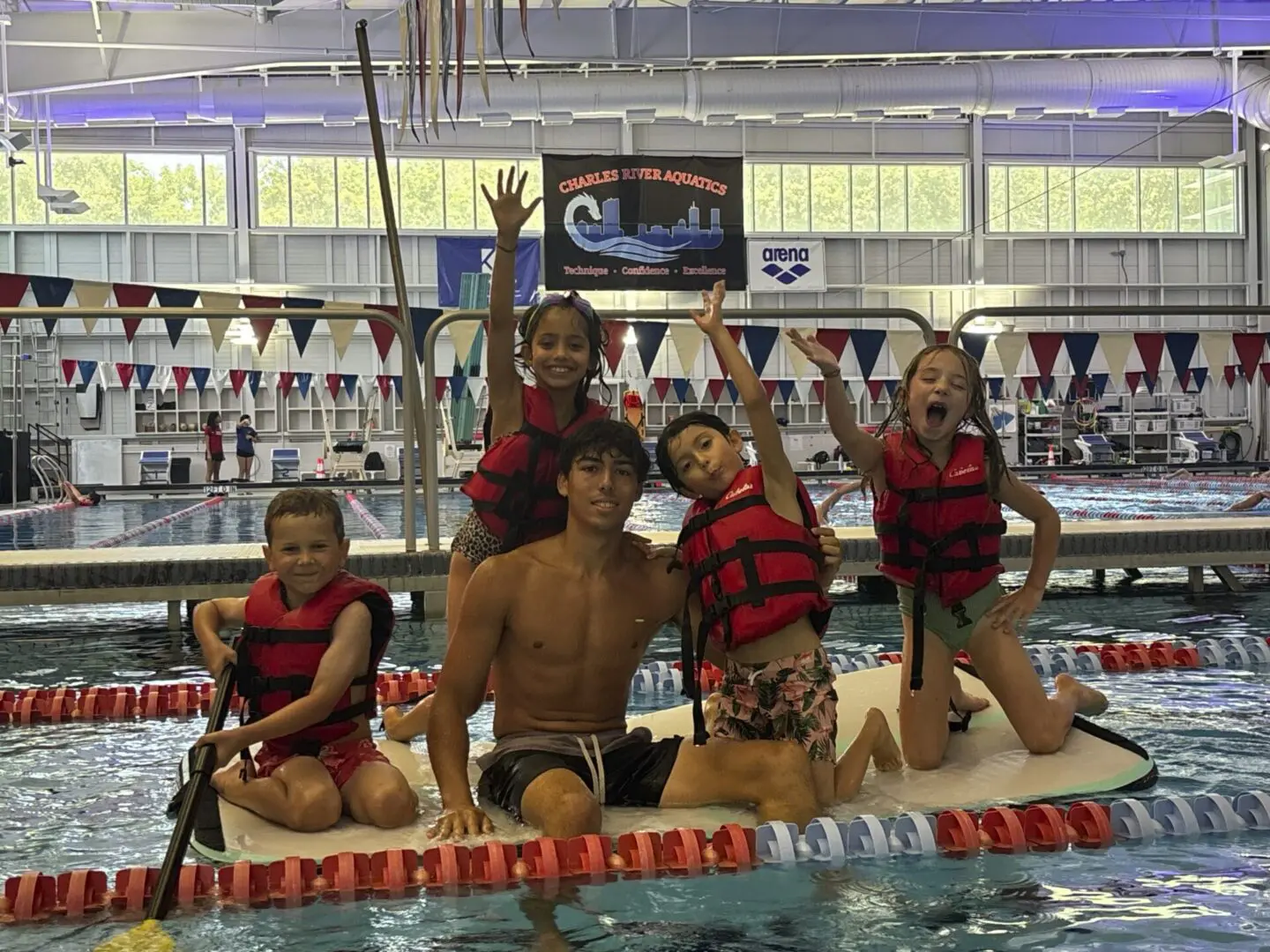 Group of kids celebrating on a floating platform.