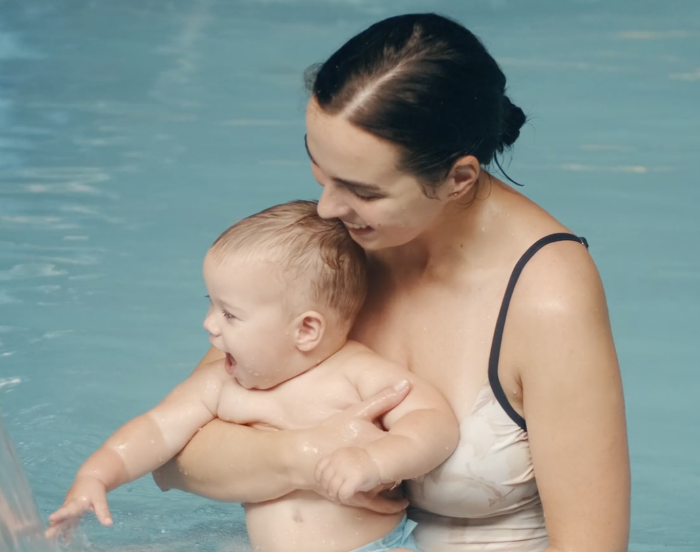 Mother and baby enjoying water play together.