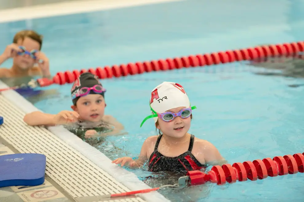 Children enjoying a swimming lesson together.