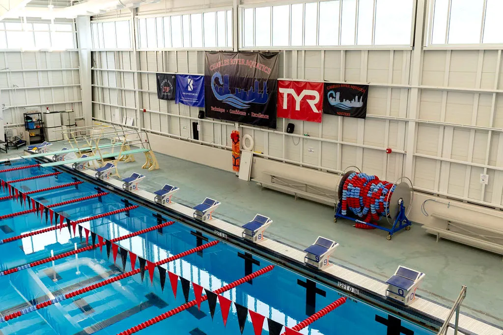 Indoor swimming pool with lanes and starting blocks ready for competition.